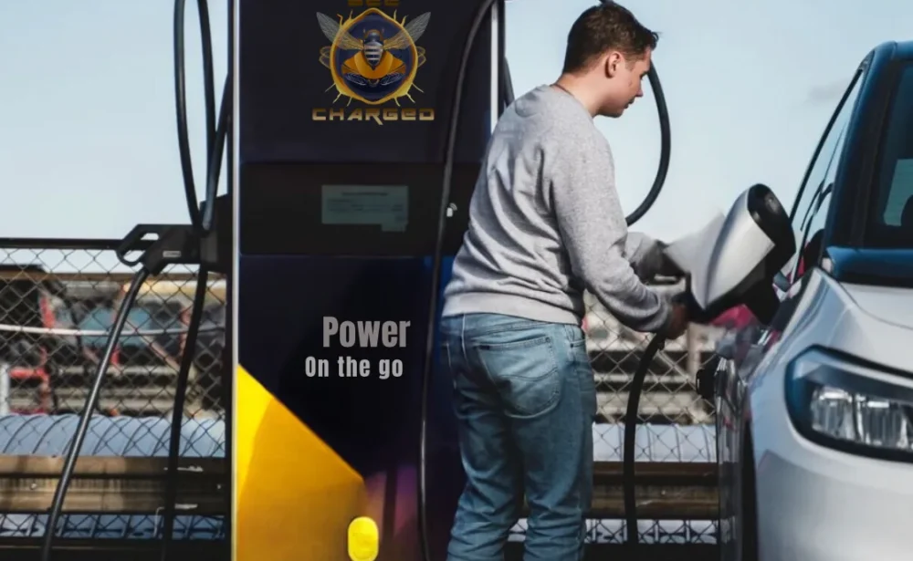 Portable EV charging station with the BEE CHARGED EV MOBILE CHARGING brand, showcasing innovative design and advanced technology. A sleek, futuristic charging pod with a glossy finish, subtly illuminated by soft, ambient lighting. The device stands on a sturdy base, with integrated wheels for easy mobility, ready to provide a reliable power boost to electric vehicles on the go. In the background, a blurred cityscape with skyscrapers and electric vehicles, hinting at the real-world application of this cutting-edge portable charging solution.